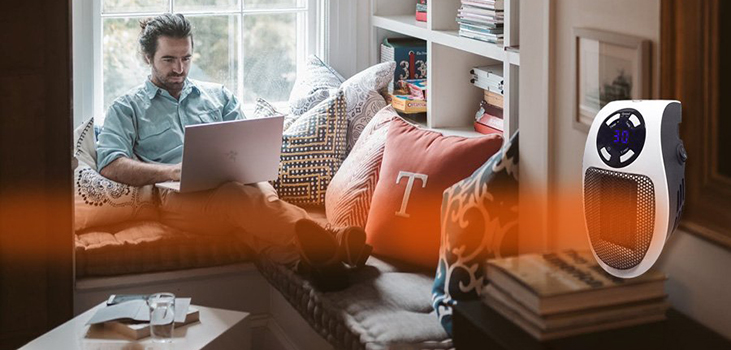 man using Toasty Heater to stay warm in his living room